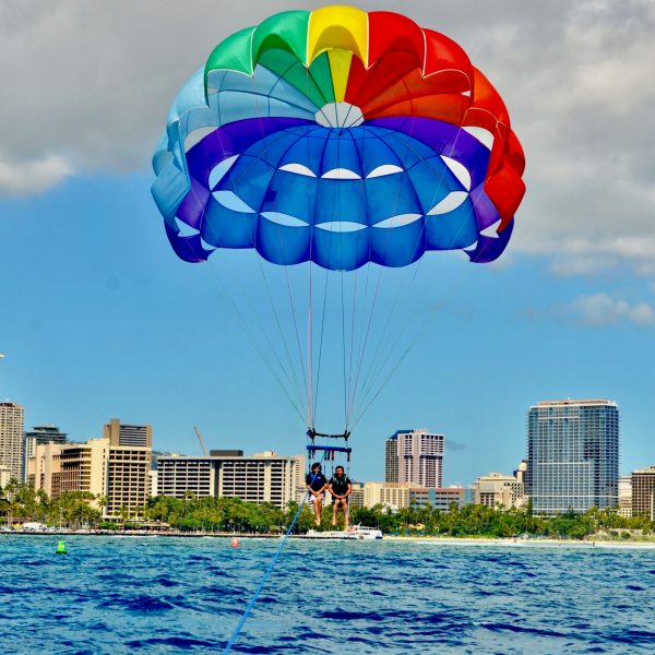 a person flying a kite in the blue water