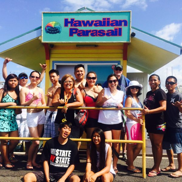 a group of people standing in front of a crowd posing for the camera