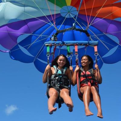a person flying through the air while holding an umbrella