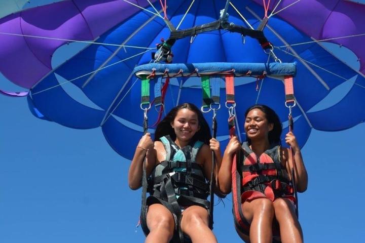 a person flying through the air while holding an umbrella