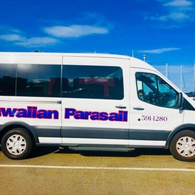 a blue and white van parked in a parking lot