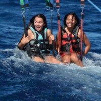 a group of people riding skis on a body of water